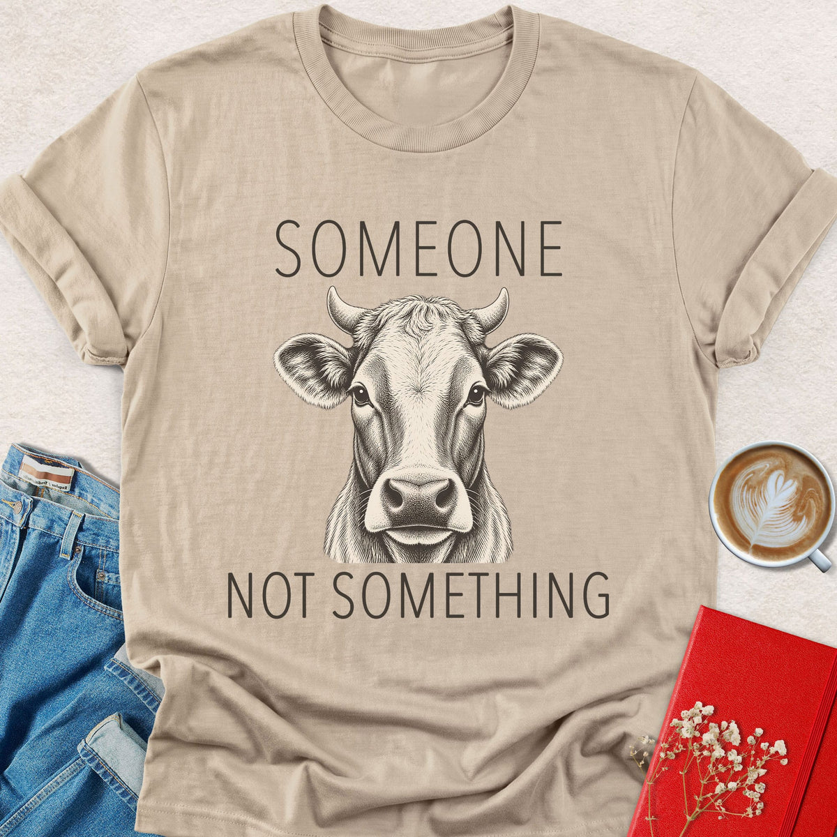 Light gray cow graphic T-shirt with “Someone” and “Not something” text