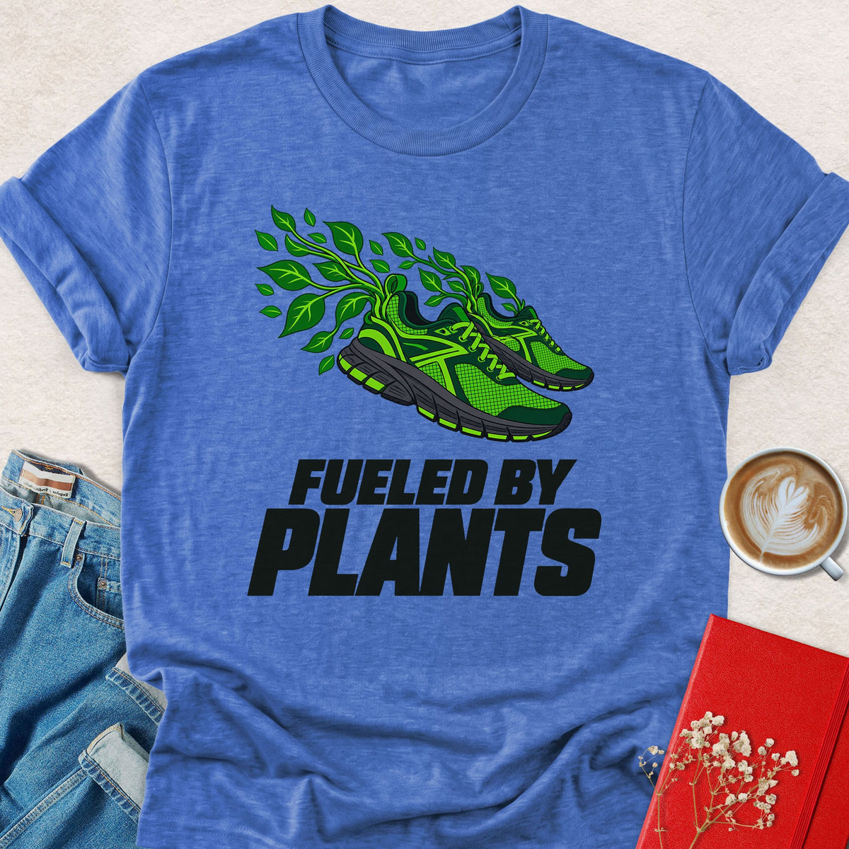Blue graphic T-shirt with green plant sneaker and 'Fueled by Plants' print