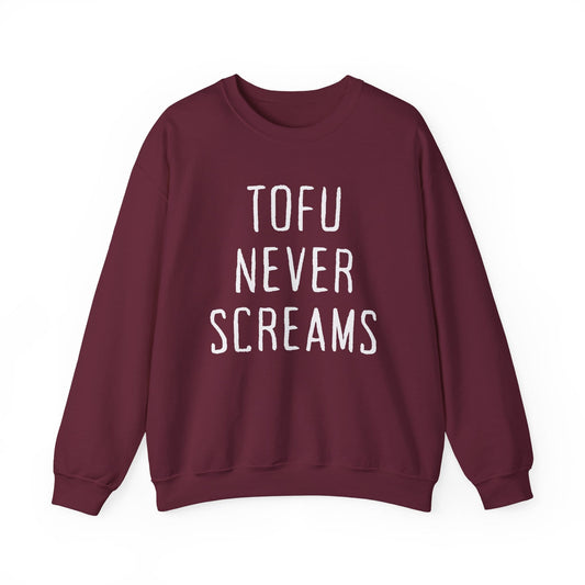 A crewneck sweatshirt in maroon with the phrase 'TOFOU NEVER SCREAMS' printed in white hand-drawn style capital letters on the front, displayed against a solid white background.