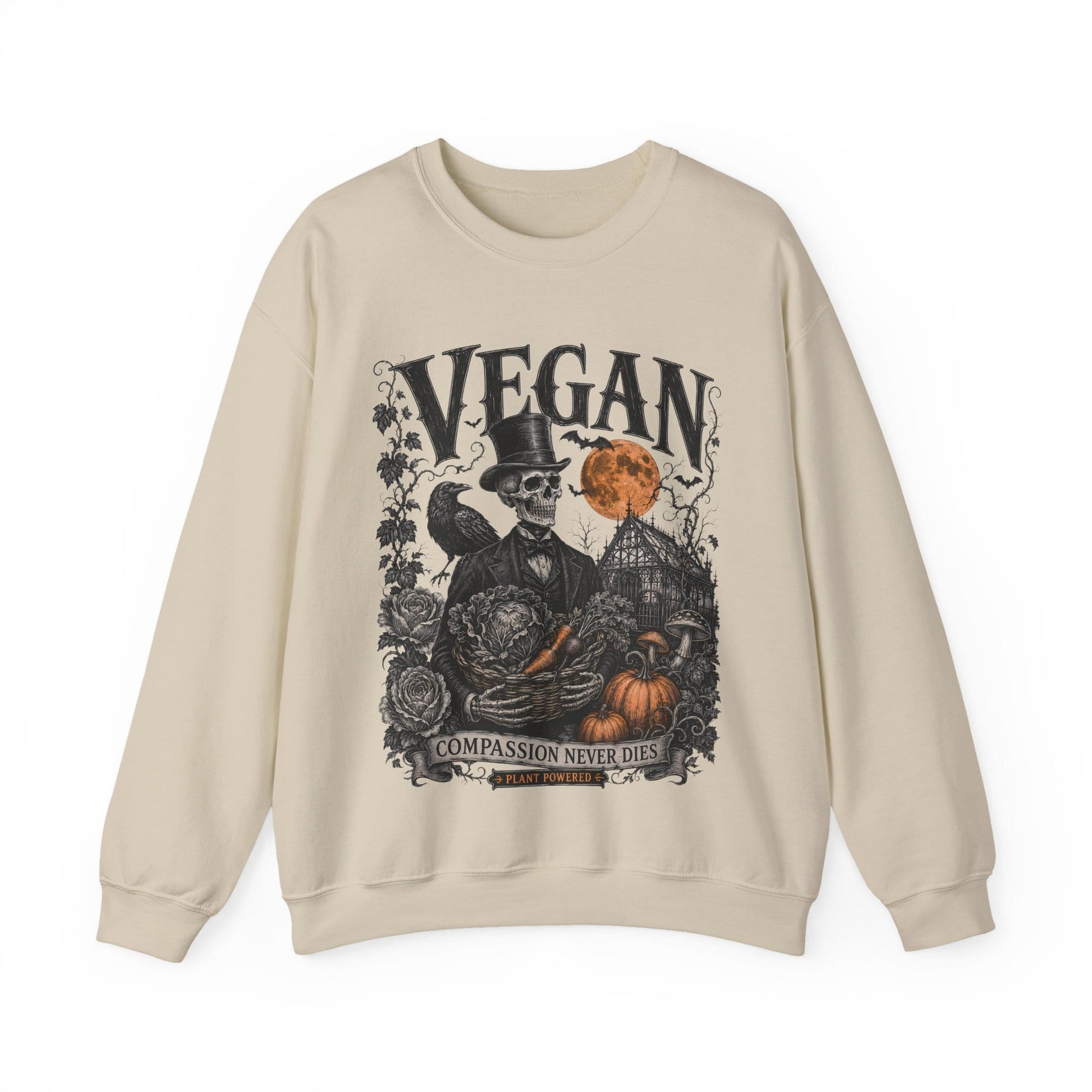 A sand crewneck sweatshirt featuring a detailed graphic print on the front. The graphic depicts a skeleton in a top hat next to a bird, with pumpkins, a haunted house, and the word 'VEGAN' in large distressed letters above.
