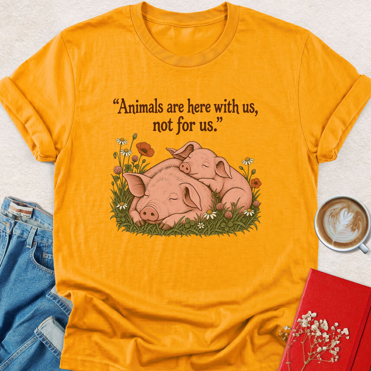 Orange T-shirt with sleeping pigs graphic on front