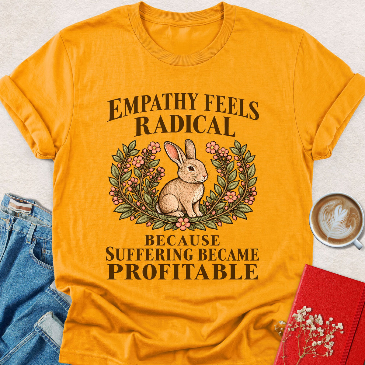 Mustard graphic T-shirt with rabbit in floral wreath and slogan on front