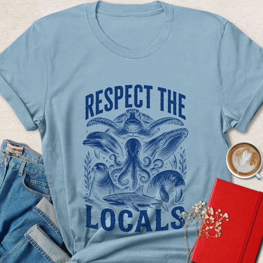 Respect the Locals vegan shirt featuring octopus, sea turtle, dolphin, whale, manatee, seal, and shark artwork.
