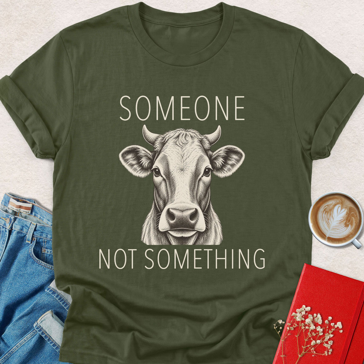 Dark green cow graphic T-shirt with “Someone” and “Not something” text