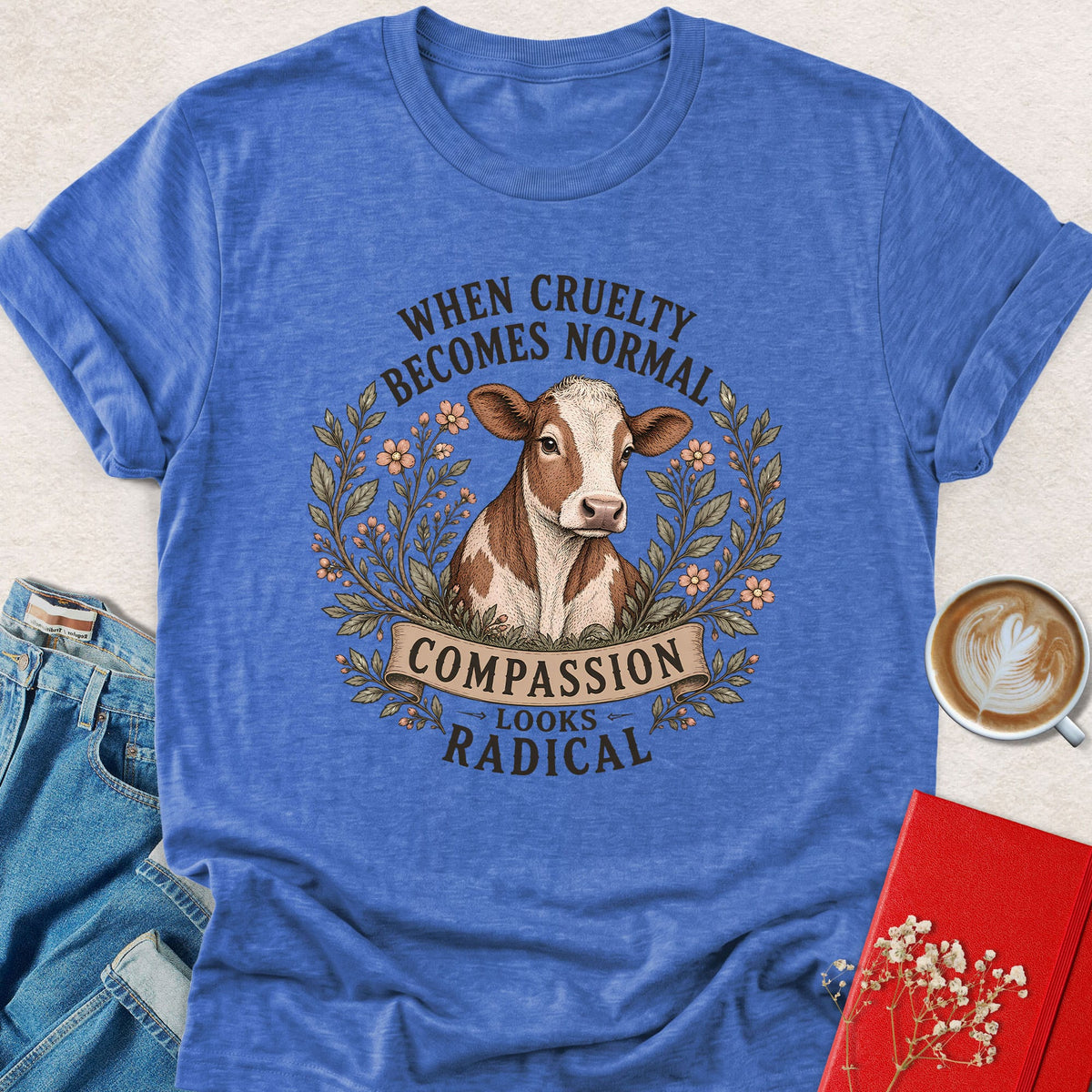 Heather royal blue cow graphic T-shirt with Compassion Looks Radical slogan