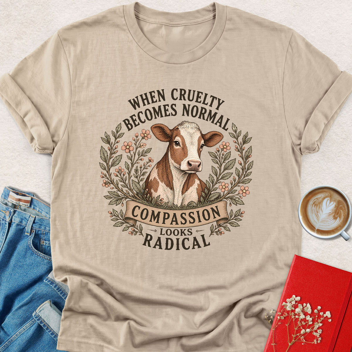 Sand cow graphic T-shirt with Compassion Looks Radical slogan