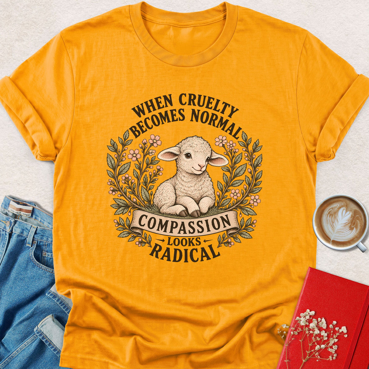 Gold lamb compassion T-shirt with floral wreath and centered slogan print