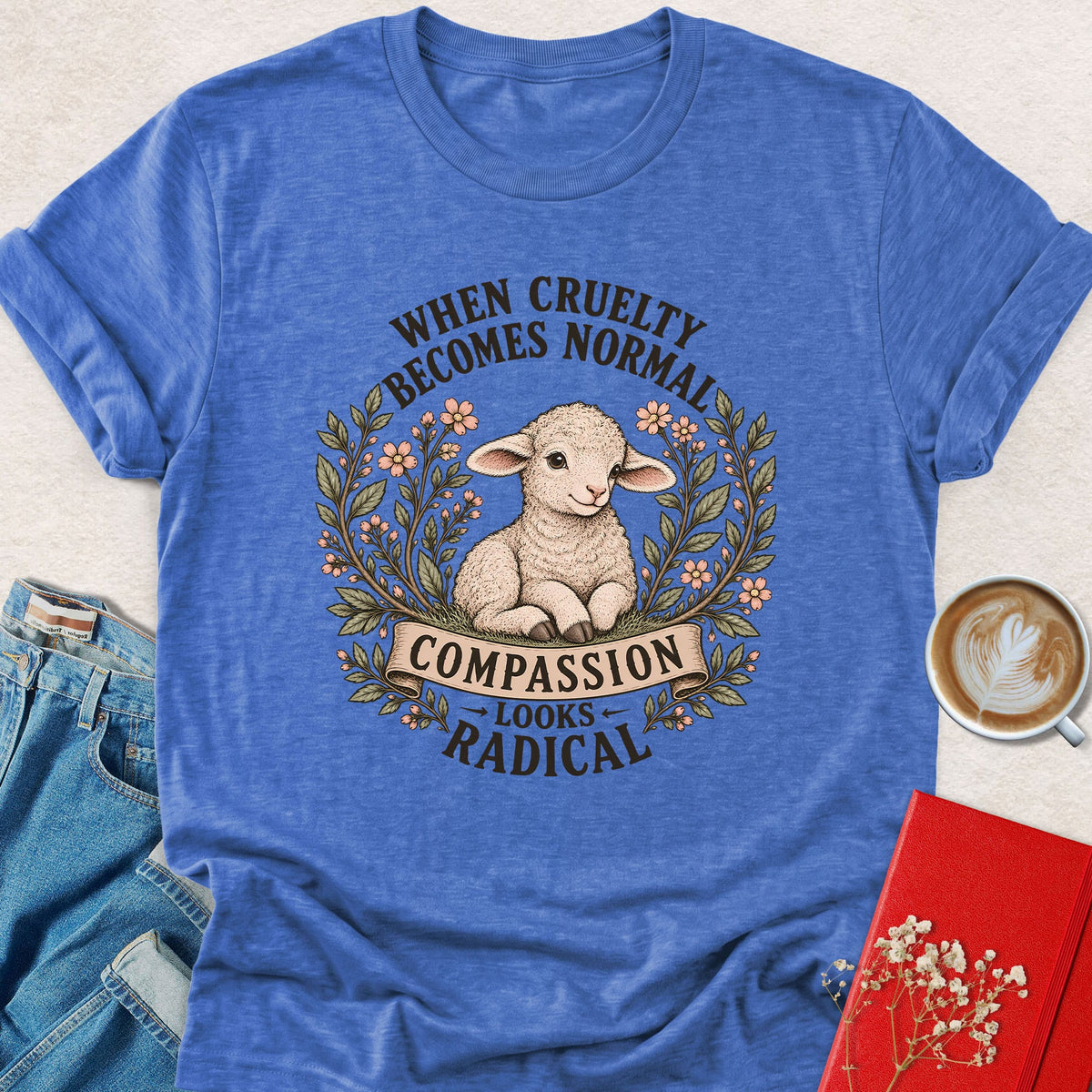 Heather blue lamb compassion T-shirt with floral wreath and 'Looks Radical' slogan