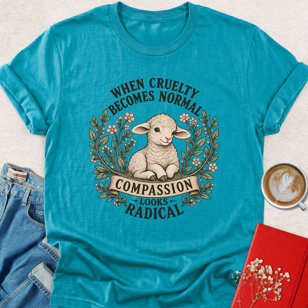 Teal lamb compassion graphic T-shirt with wreath and slogan print