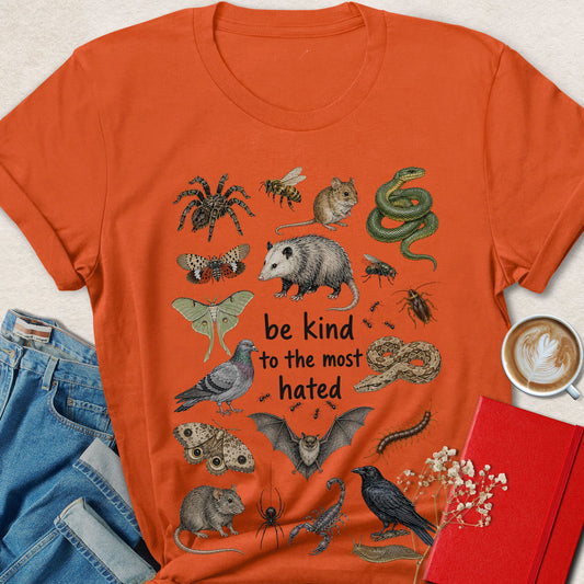 Orange graphic crewneck T-shirt with animal-heart print and 'be kind' message