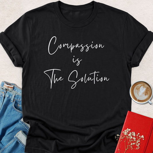 Black graphic T-shirt with “Compassion is The Solution” text