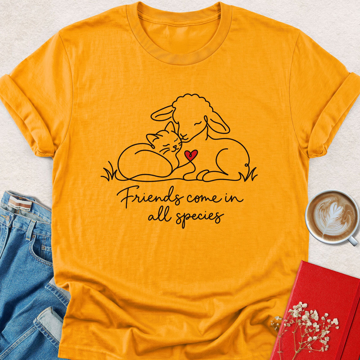 Gold T-shirt with animal friends graphic and "Friends come in all species" text on front.