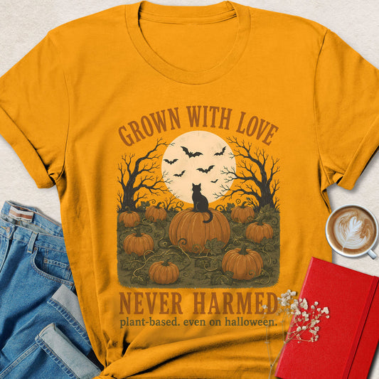 Gold Halloween graphic t-shirt with bats, pumpkins, and 'GROWN WITH LOVE' text.