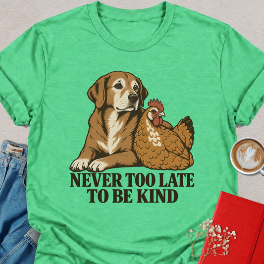 Green T-shirt with dog and rooster graphic and “Never Too Late to Be Kind” text