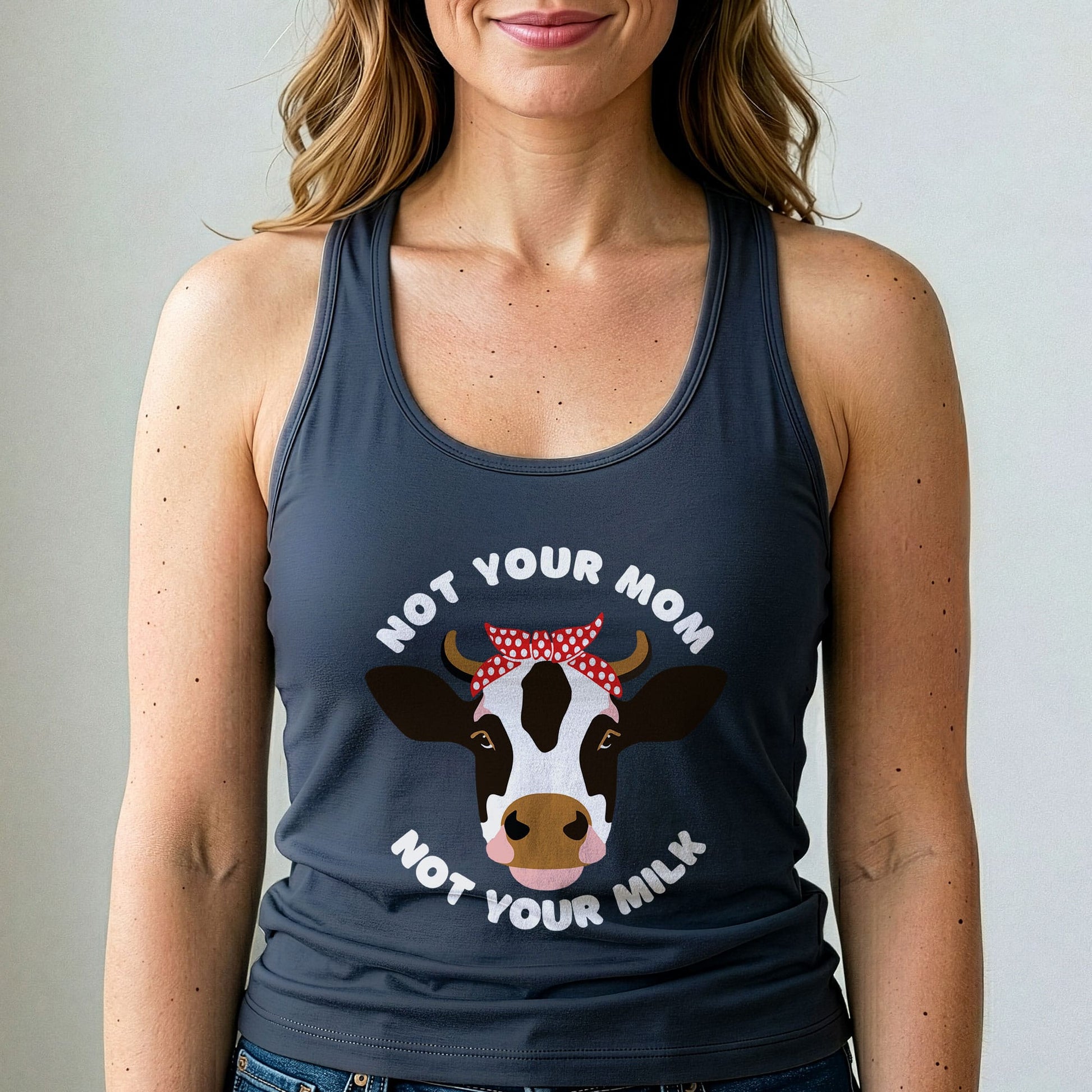 Person wearing a tank top with a cow graphic and text.