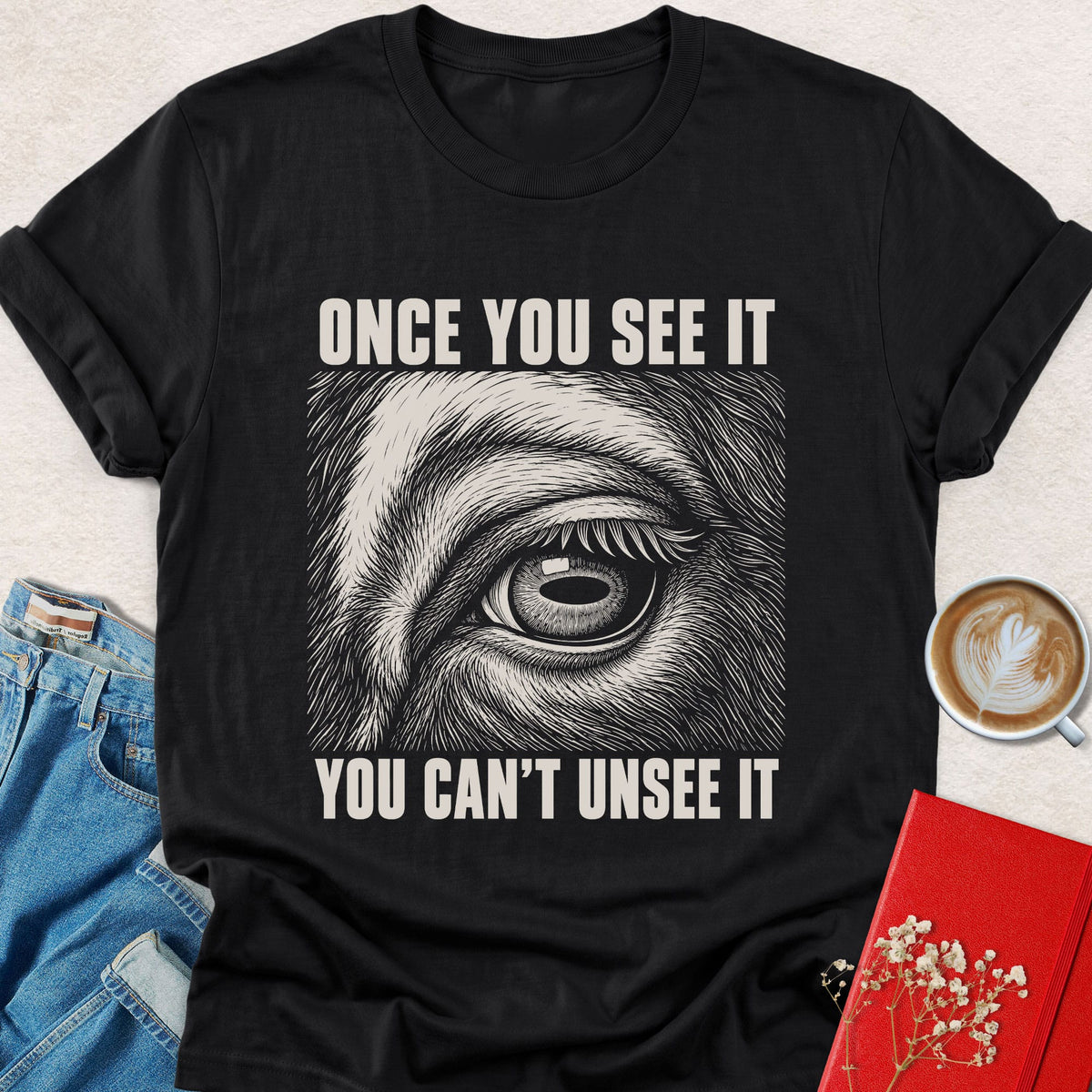 Black crewneck T-shirt with animal eye graphic and 'Once You See It' text