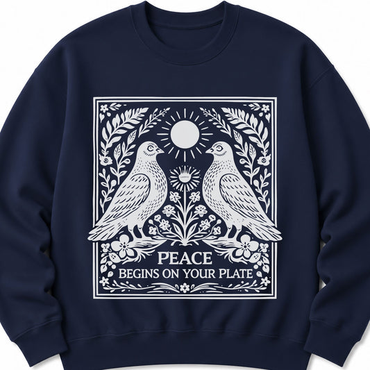 Navy sweatshirt with front graphic of two birds, sun, and “PEACE BEGINS ON YOUR PLATE”