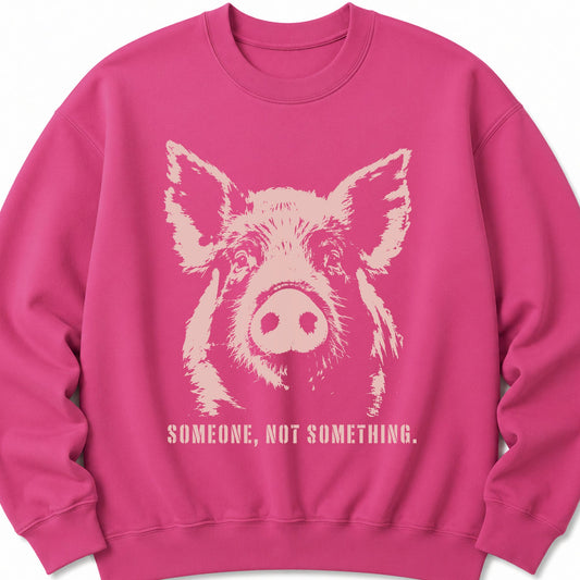 Unisex pink sweatshirt with pig graphic and “Someone, Not Something” text