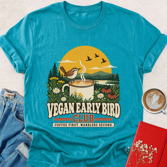 Teal graphic T-shirt with bird feeding at steaming coffee cup and floral scene print