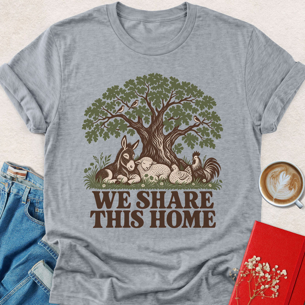 Heather gray crewneck T-shirt with tree-and-animals graphic and 'WE SHARE THIS HOME' text