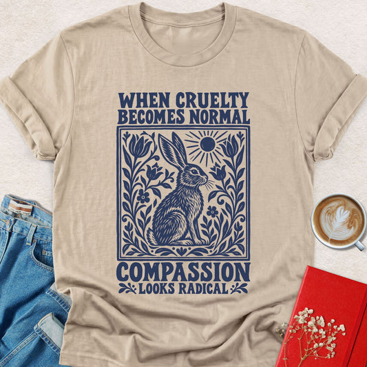 Sand graphic T-shirt with “When Cruelty Becomes Normal Compassion” rabbit front print