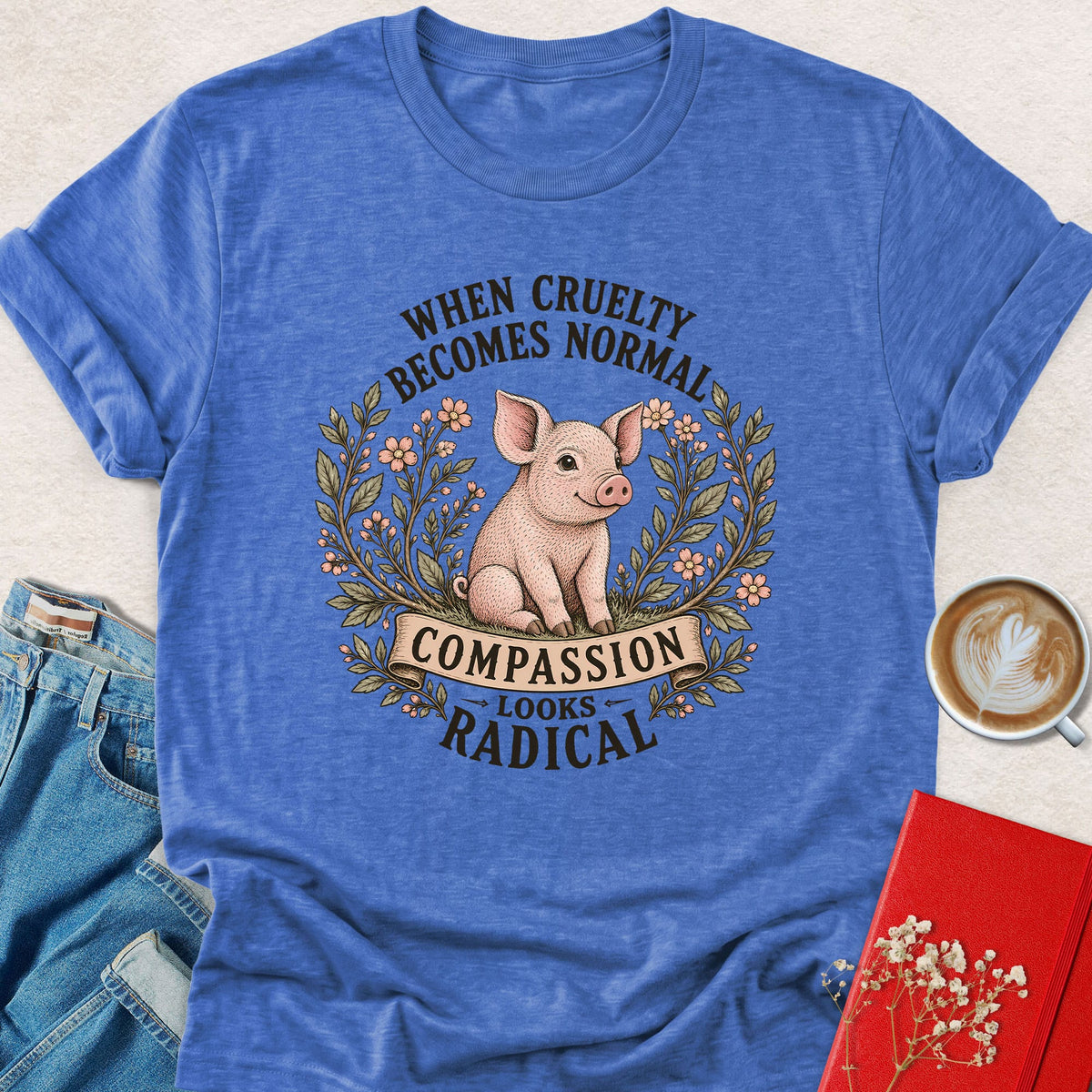 Blue pig graphic t-shirt with floral wreath and quote text, crew neck