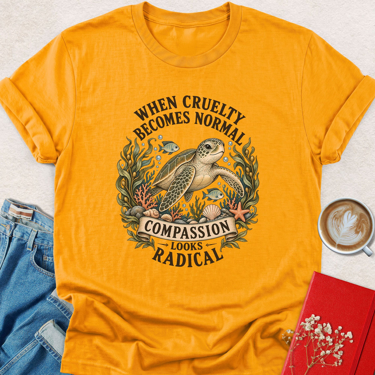 Gold crewneck sea turtle graphic T-shirt, 'Compassion looks radical' print
