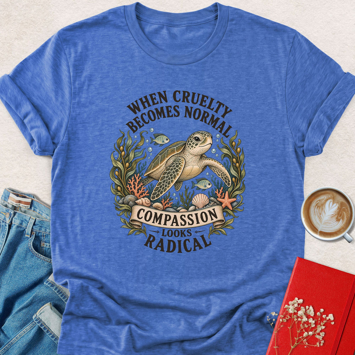 Tropical blue crewneck sea turtle graphic T-shirt, 'Compassion looks radical' print